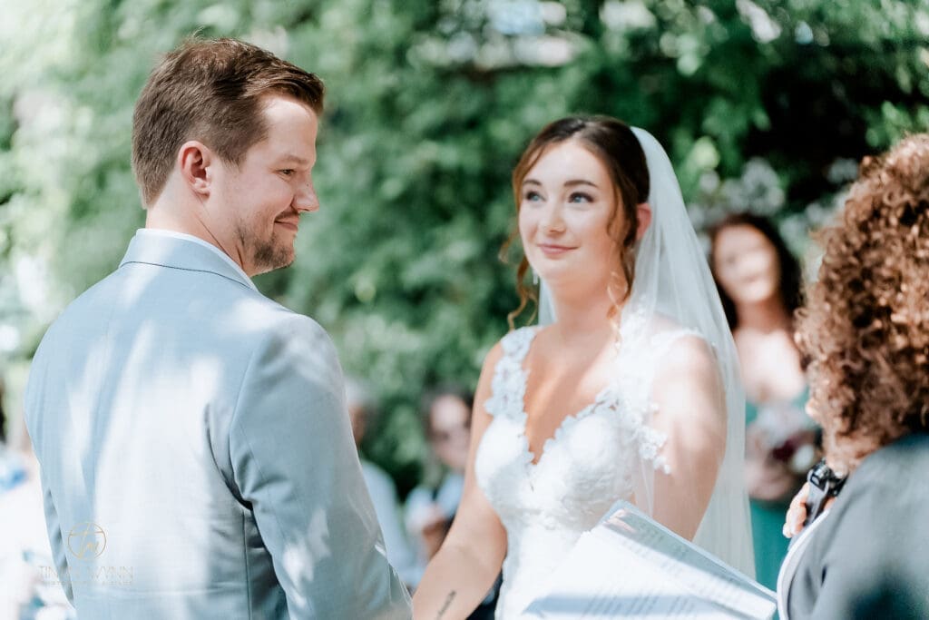 Bride quietly glancing at groom in a candid, unposed wedding moment, Dallas Fort Worth wedding photographer